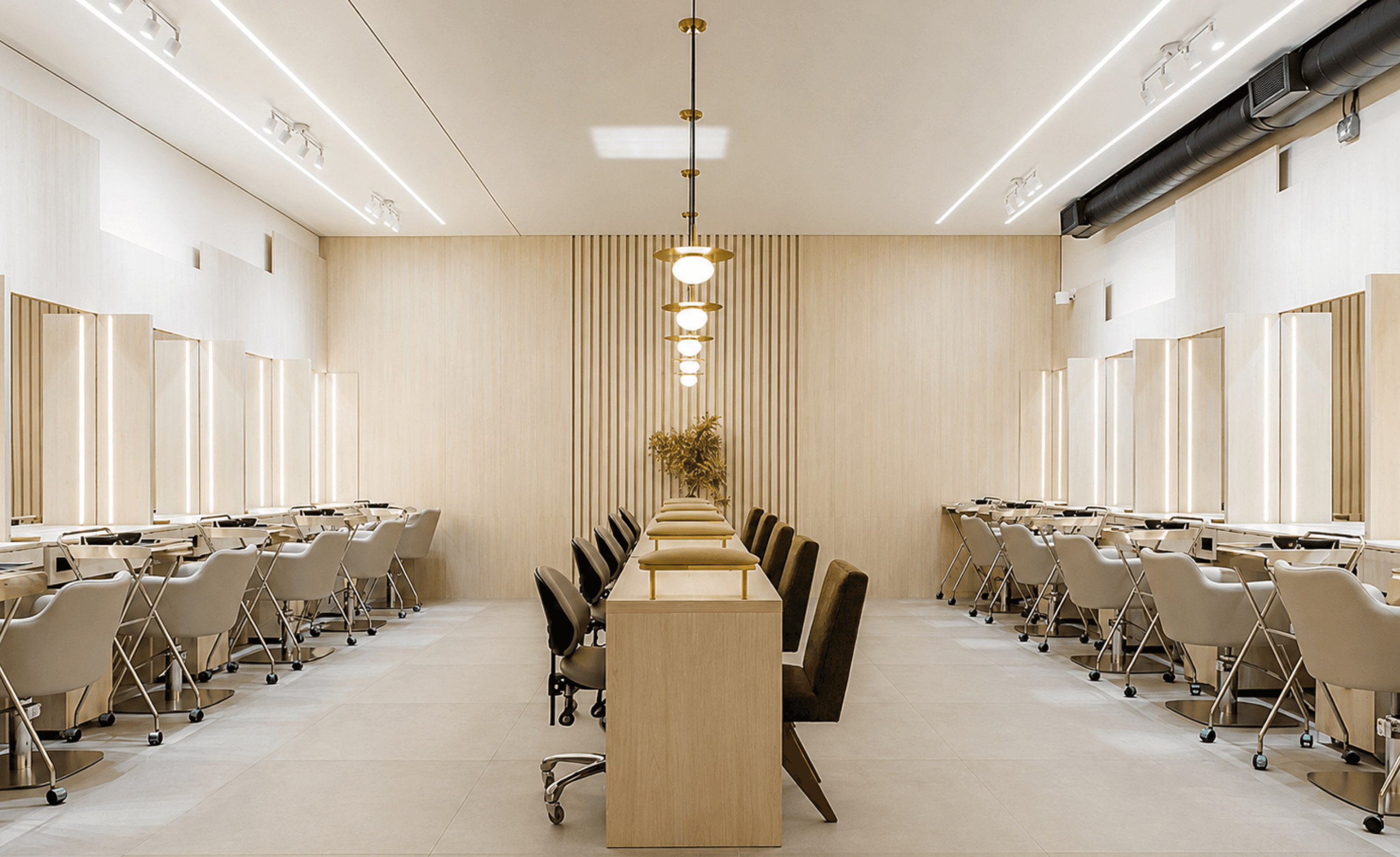 The All Star Concept salon floor in Midtown Miami, cream interiors with brass pendant lights